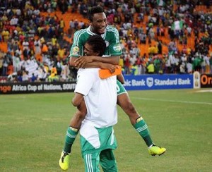 Eureka!...Mikel Obi hugs Ex-Eagle star, Kalu following the Eagles qualification for the 2014 world cup tournament