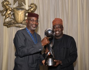Sports Minister, Bolaji Abdullahi presents the World Under-17 trophy to Gov. Imoke in Calabar