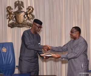 Gov. Liyel Imoke of Cross River presenting a souvenir to the  Resident Electoral Commissioner for the state, Dr. Okey Ezeani when the REC led his management team on a courtesy visit to Government House, Calabar.
