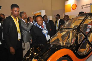 L- R. Eloghosa Iyamu, a student of the University of Benin, former Adviser to the President on Petroleum, DrEmmanuel Egbogah inspecting a car built by students of the institution for the Shell Eco-marathon competition at the 2015 conference and exhibition of the Society of Engineers in Lagos. 