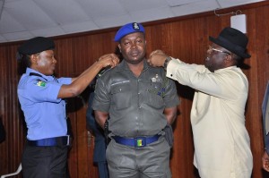New Ebonyi State Commissioner of Police, Peace Abdallah and Governor David Umahi decorating the governor's ADC,Ogbonnaya Nwota, with his new rank of Superintendent of Police in Abakaliki recently