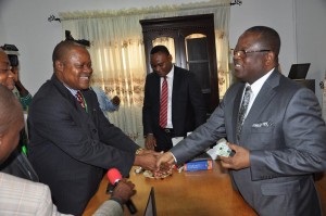  Governor David Umahi holding his new E-ID card after being registered by a team of the National identity Management Commission at the Government House in Abakaliki recently 