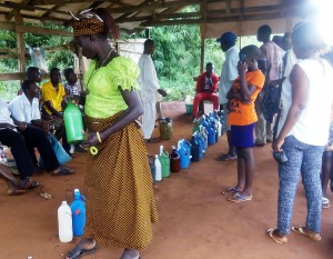 A POTENTIAL CUSTOMER CHECKS OUT BEFORE PURCHASE AT A PALMWINE MARKET, NEW AFOR UMABOR MARKET, EHA ALUMONA COMMUNITY, ENUGU STATE.2/11/2015