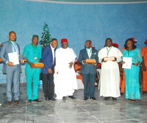 Governor David Umahi of Ebonyi State (centre); Deputy Governor Kelechi Igwe (3rd left); Commissioner for Works, Fidelis Nweze (left); Commissioner for Power, Emmanuel Uguru (2nd left); Commissioner for Finance, Dennis Ekumankama (3rd right); SSA to the Governor on Religion and Welfare Matters, Abraham Nwali (2nd right); and Commissioner for Culture and Tourism, Euphemia Nwali, at 2015 Ebonyi State Merit Award in Abakaliki on Wednesday. Photo: EBSG